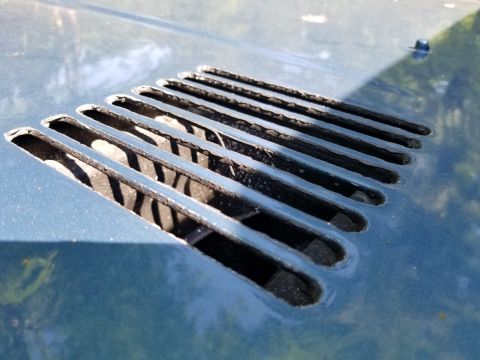 1974 Ford Bronco - It looks like the body was painted blue, then these slots were taped up from the outside, and the underside of the hood was bedlined.