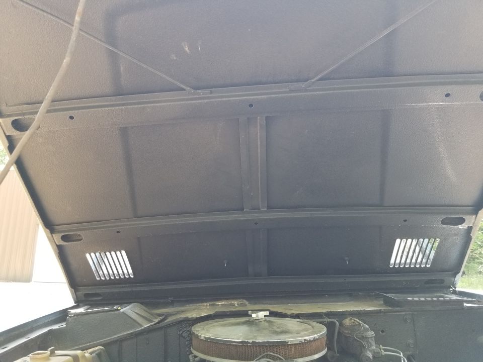 The hood looks OK, but the bedliner goes out to the surface of the paint on the vent louvers.  The prop rod is mangled.