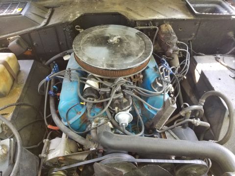 1974 Ford Bronco - The battery is being kept away from shorting against the body by a 2x4; the coolant overflow hose is split & loose; the PS was very low. [u…