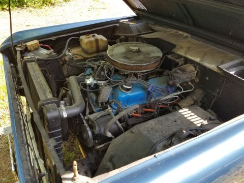 1974 Ford Bronco - The battery is being kept away from shorting against the body by a 2x4; the coolant overflow hose is split & loose; the PS was very low. [u…