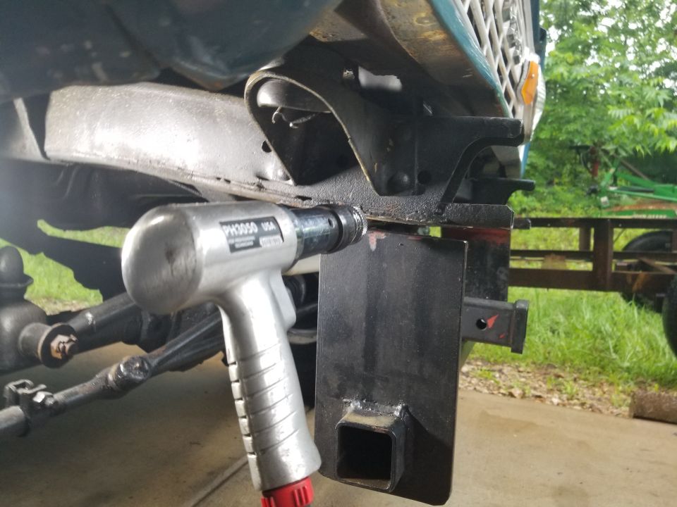 Eventually, I felt like I had weakened the welds enough, and they broke with a little encouragement.  I put some vise grips on this side, and went to work on the HARD side - where the steering box & track bar bracket are in the way.