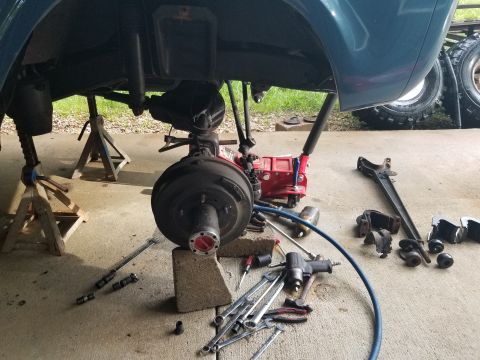 1974 Ford Bronco - At this point, I've unbolted the shock, removed the front diff. vent nipple so there's more slack for the hose, removed spring upper retain…