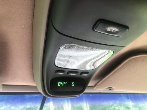1994 Ford Bronco - The interior overhead console of a vehicle displays a digital thermometer reading 84 degrees Fahrenheit and the letter 'S'. Above the displ…