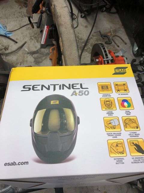 1992 Jeep Wrangler - A box for an ESAB Sentinel A50 welding helmet is shown in a workshop setting.