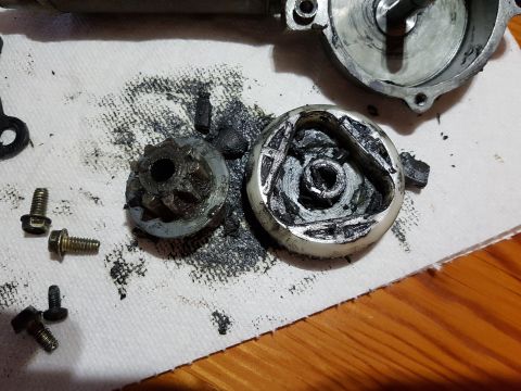 1978 Ford Bronco - A disassembled automotive starter motor assembly is shown on a white paper towel. The components include a gear, a white plastic housing wi…