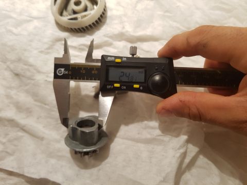 1978 Ford Bronco - A digital caliper measures a metal part. The caliper reads 24.81 mm.