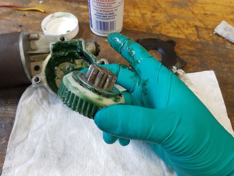 1978 Ford Bronco - Greasing a gear assembly for a motor component, likely for automotive repair or maintenance.