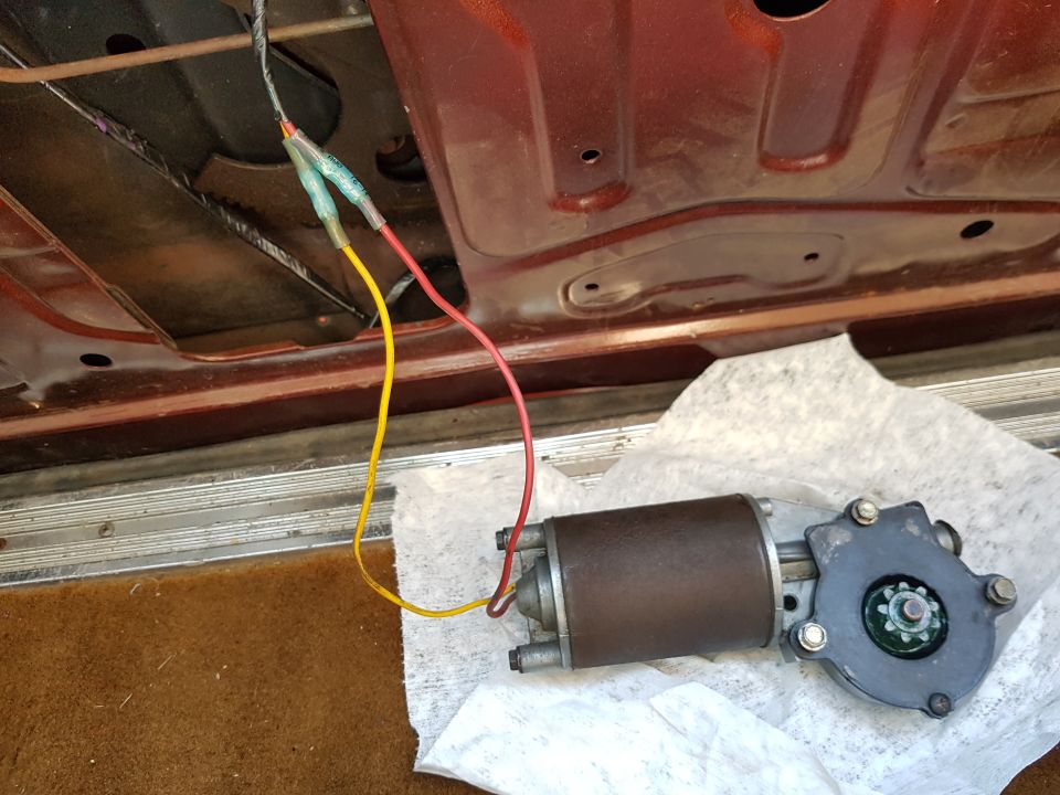 car door window motor with red and yellow wires connected