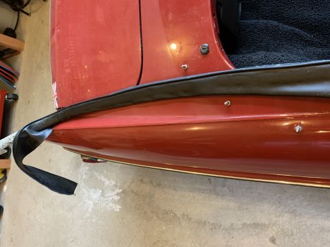 1979 Ford Bronco - Close-up of a red vehicle's door edge and weather stripping, with a Supermotors.net logo visible at the bottom right.