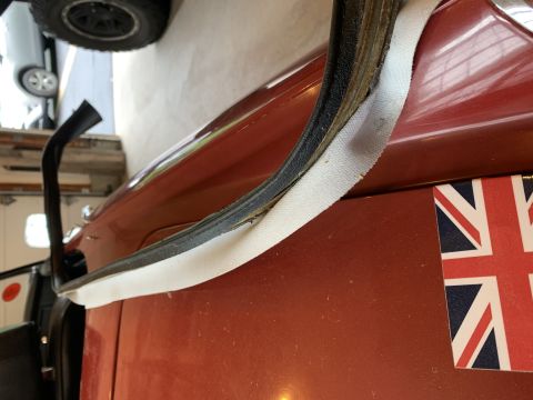 1979 Ford Bronco - Detail of a door seal and a Union Jack sticker on a vehicle's exterior.