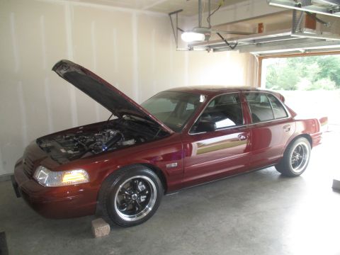 2004 Ford Crown Victoria - 2004 Ford Crown Victoria in a garage, hood is open showing the engine bay.
