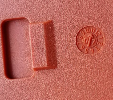2000 Ford Crown Victoria - A circular stamp on a red plastic component shows a date code, possibly indicating the year 2007.