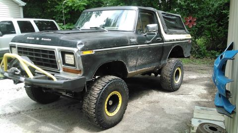 1978 Ford Bronco - This lifted Ford Bronco has a custom yellow bumper and yellow accents on its wheels.