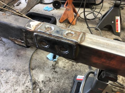 1992 Jeep Wrangler - A section of a vehicle frame shows recent welding work, with shop equipment visible in the background.