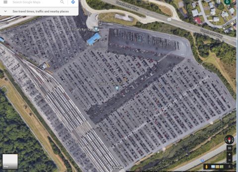 2000 Ford Crown Victoria - Aerial view of a large car lot, identified as Twin Oaks Rail Yard, filled with numerous vehicles.