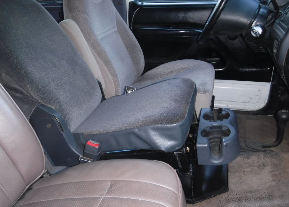 Interior view of truck bucket seats and center console with cup holders