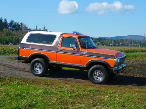 1978 Ford Bronco - This 1978 Ford Bronco is seen from a three-quarter front angle on a dirt road with fields in the background.