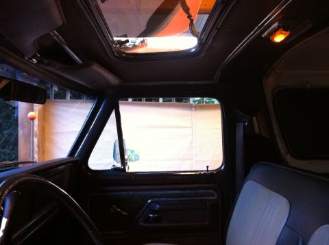 1978 Ford Bronco - The interior of a vehicle is visible, including a sunroof and dashboard details.