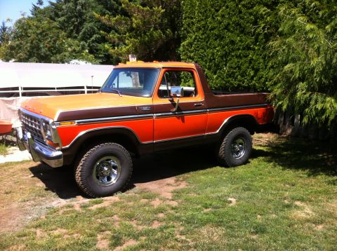 1978 Ford Bronco - This two-tone 1978 Ford Bronco is shown in a three-quarter front view, parked outdoors on a sunny day.