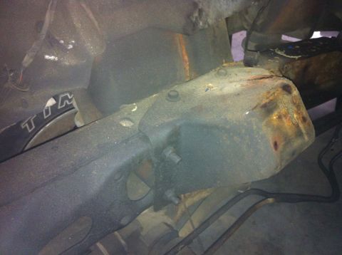 1978 Ford Bronco - Undercarriage view of a vehicle, focusing on the frame and suspension system components.