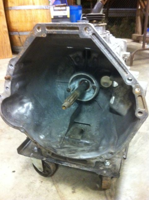 1978 Ford Bronco - Transmission bell housing with input shaft visible, mounted on a cart.