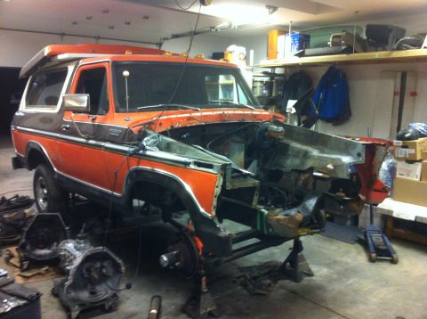 1978 Ford Bronco - This 1978 Ford Bronco is undergoing repairs, with its front end disassembled and the vehicle supported by jack stands.