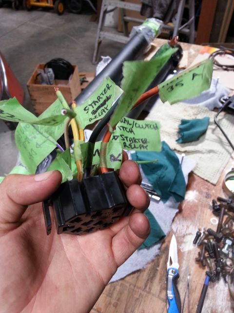 1978 Ford Bronco - A hand holds a labeled wiring harness, likely for a vehicle's starter relay and ignition system.
