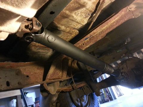 1978 Ford Bronco - Undercarriage view of a vehicle, highlighting the driveshaft and suspension components.