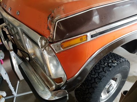 1978 Ford Bronco - Front view of a 1978 Ford Bronco showing its orange and brown paint scheme and chrome accents.