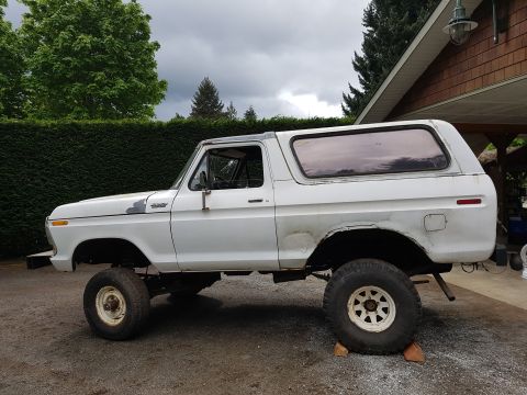 1978 Ford Bronco - This 1978 Ford Bronco is shown from the side, parked on gravel near a building.