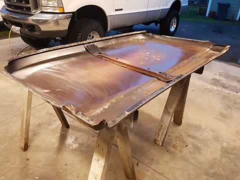1978 Ford Bronco - A detached hood rests on sawhorses, with a white Ford truck visible behind it.