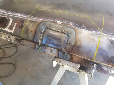 1978 Ford Bronco - Close-up of a metal panel undergoing repair, showing recent welding work and measurement lines.