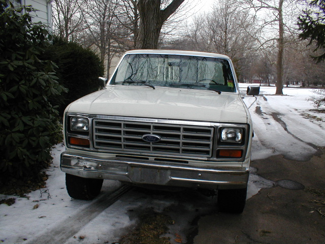 1986 Ford F-150 pickup truck front view in snowy driveway