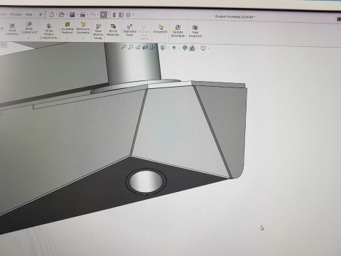 1978 Ford Bronco - SolidWorks model detail of a front bumper assembly showing the shaped end cap with a round fog/driving-light cutout.