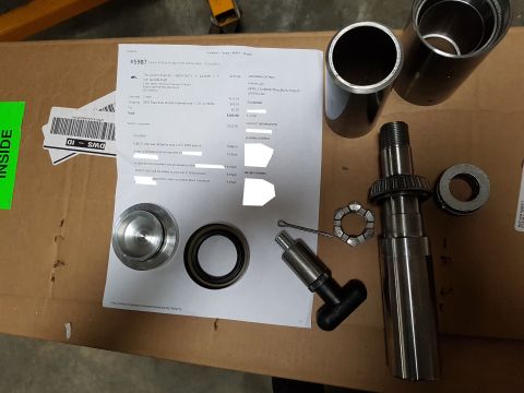1978 Ford Bronco - A receipt and various vehicle parts are laid out on a cardboard box.
