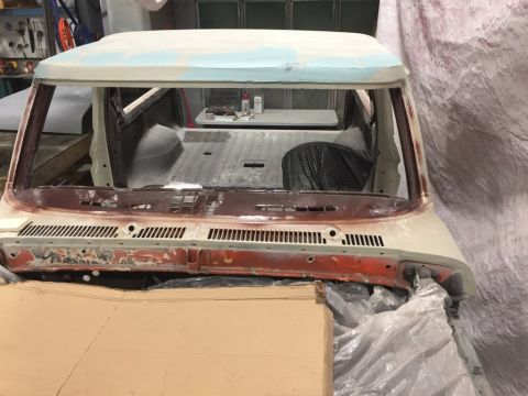 1978 Ford Bronco - This vehicle is in a workshop, covered in plastic sheeting and undergoing repairs. The interior and bed are visible.