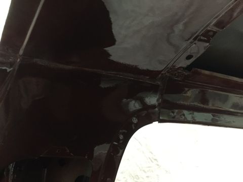 1978 Ford Bronco - Close-up of the interior metal structure, revealing the dark red paint and visible seams.
