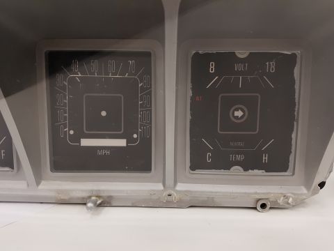1978 Ford Bronco - Close-up of a vehicle's instrument cluster, showing the speedometer and temperature gauges.