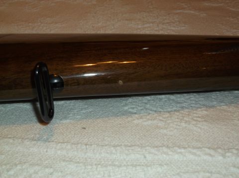 1995 Mercury Grand Marquis - Close-up of a wooden trim piece with a black handle, showing minor imperfections.
