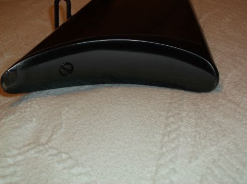 1995 Mercury Grand Marquis - Close-up of the end of a black gun stock, showing a screw head.
