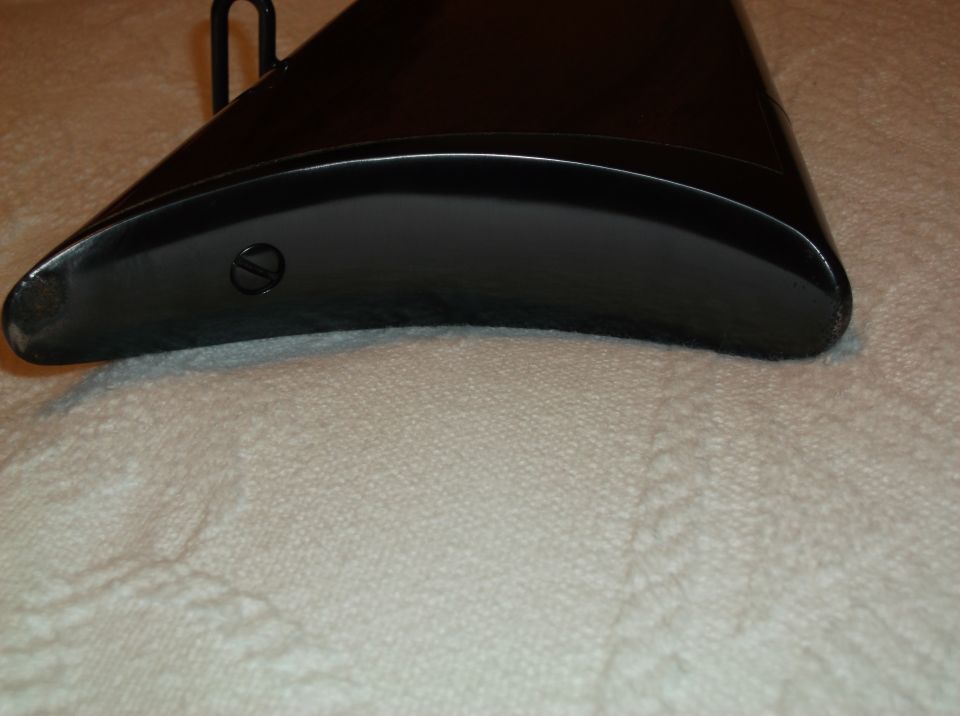 Black gun stock end with a screw visible