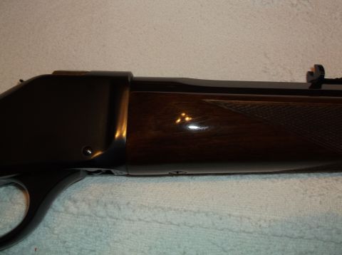 1995 Mercury Grand Marquis - Close-up of a Browning rifle, showing the wood grain and metal finish.