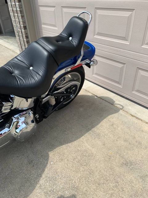 2008 Harley-Davidson Softail - A blue Harley-Davidson motorcycle is parked on a concrete driveway in front of a closed garage door.