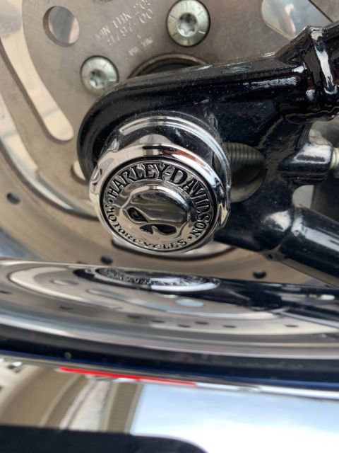 2008 Harley-Davidson Softail - Chrome axle nut with Harley-Davidson Motorcycles logo and skull detail.