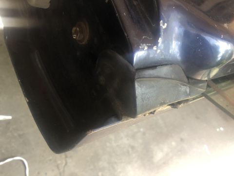 1995 Ford Bronco - This photo shows a close-up of a vehicle's rear bumper corner, revealing wear and tear on the black trim.