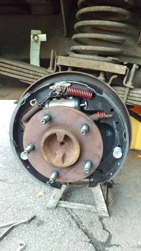 1988 Ford Bronco - Close-up of a vehicle's rear drum brake assembly, showing internal components and suspension.