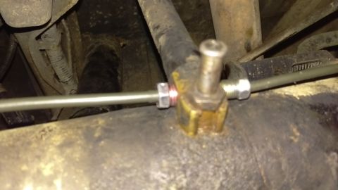 1988 Ford Bronco - A close-up view of a brake line fitting, highlighting the connection point for the brake hose.