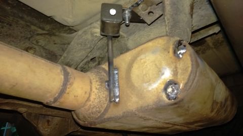 1988 Ford Bronco - Custom bracket welded to exhaust system components, likely for a repair or modification.