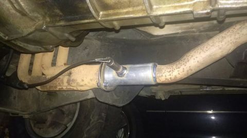 1988 Ford Bronco - This photo shows a close-up of a vehicle's exhaust system, including the manifold and an oxygen sensor.