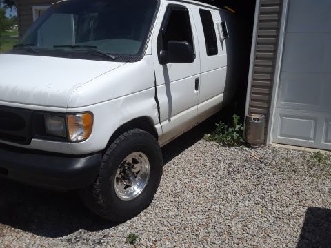 1999 Ford E250 - This 1999 Ford E250 van is seen from a 3/4 front angle, partially entering a garage.